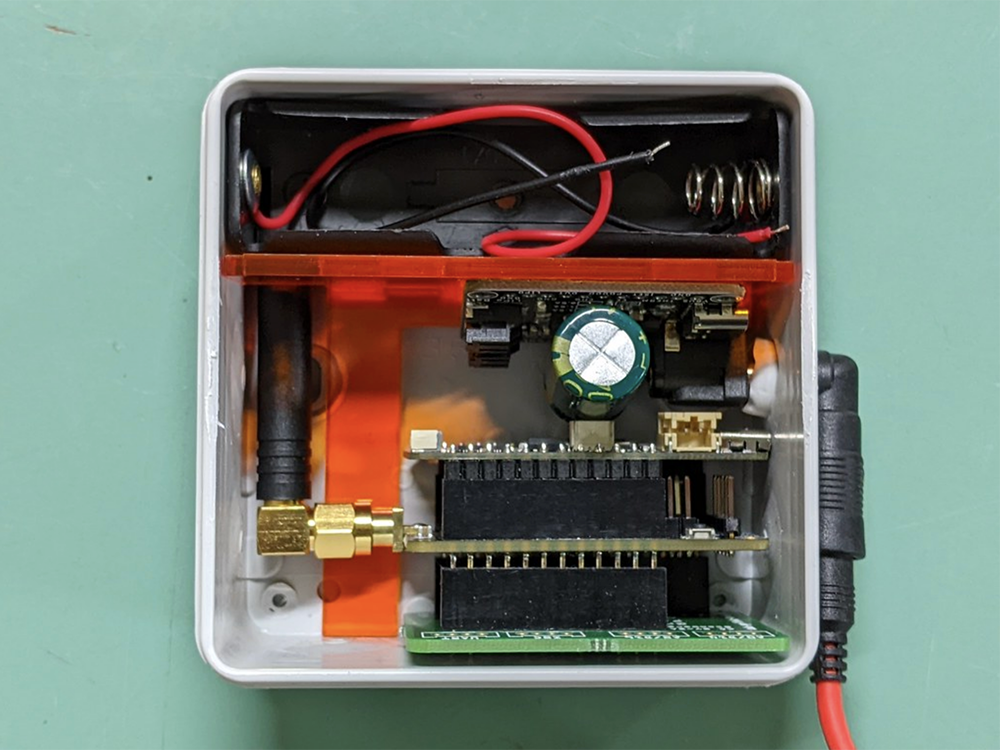 PAX-Counter: open electrical junction box with electronic components including integrated antenna.